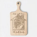 personalized-home-map-cutting-board-housewarming-gift-1 Personalized maple wood cutting board engraved with a custom house map, address, and the family name - perfect for realtor closing gifts or new homeowners.
